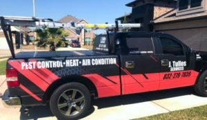 Service vehicle of an HVAC company equipped with tools and branding for pest control, heating, and air conditioning services.