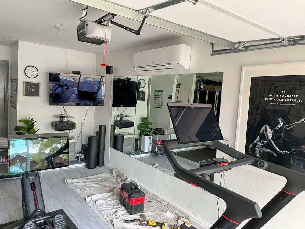 A well-equipped home gym with an air conditioning unit ensuring a comfortable workout environment.