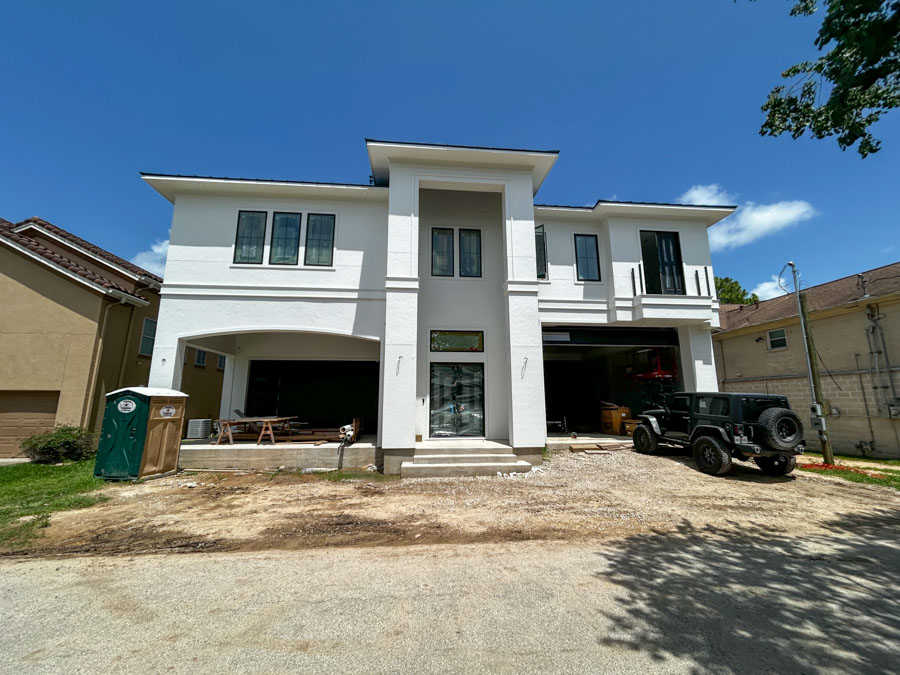 A modern two-story residential home with a designated area for air conditioning unit installation.
