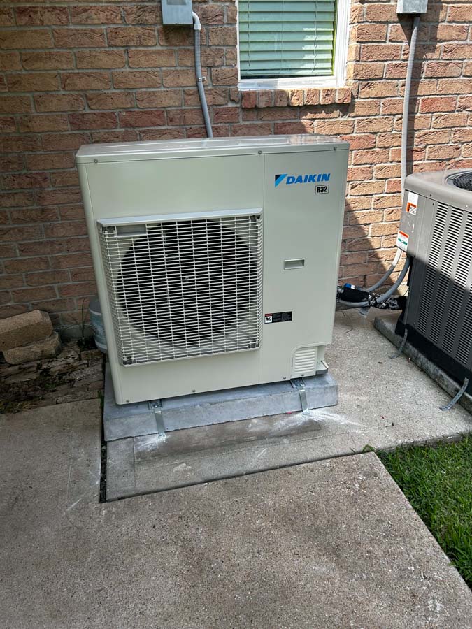 Reliable J.Tullos Service technician performing a thorough air conditioning system check in Texas City home