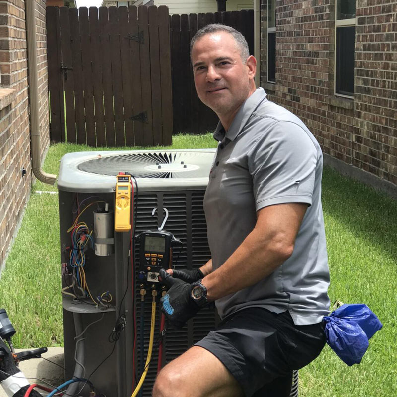 Experienced HVAC contractor checking refrigerant levels and airflow with professional diagnostic tools
